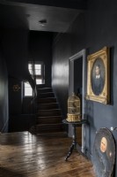 Dark grey painted classic hallway with wooden flooring