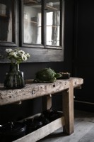 Detail of rustic wooden workbench in black kitchen