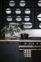 Display of white plates in black wall rack