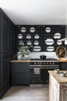 Display of white plates in wall rack in modern country kitchen
