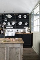 Black and white kitchen with distressed wooden island 
