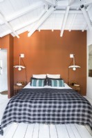 Modern country bedroom with brown painted feature wall