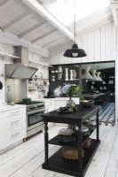Monochrome country kitchen with view to dining room beyond