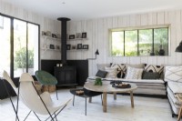 Monochrome country living room with corner sofa and wood burner