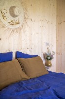 Straw hat on wooden wall of modern country bedroom