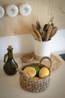 Detail of country kitchen worktop with basket of fruit