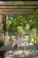 Outdoor dining table on wooden veranda