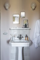 Classic style sink in bathroom with three mirrors on wall above