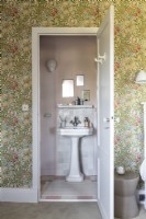 View into classic style bathroom through bedroom door