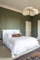 Classic style bedroom with green painted walls and white bedding