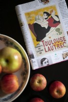 Art book and apples on table - detail