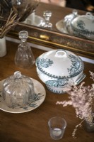 Antique crockery and glassware on wooden sideboard