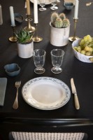 Detail of place setting on dining table with black tablecloth