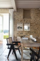 Wooden table and exposed stone walls in country dining area