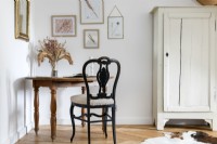 Small table and old wooden chair next to distressed wardrobe