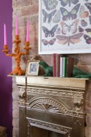 Gold painted Victorian reclaimed fireplace against an exposed brick chimney breast