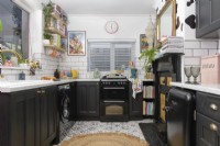 View into a monochrome kitchen with patterned floor tiles