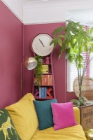 Grandfather clock with shelves in a pink living room