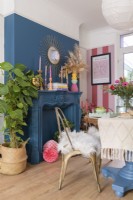 Blue wall and painted fireplace surround in a dining room