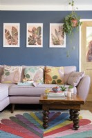 Pink sofa and wooden coffee table in a blue living room