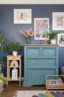 Green chest of drawers in a blue living room