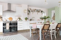 Spacious pale pink and green modern kitchen/diner