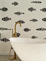 Tub Bath with golden faucet and fish patterned wallpaper
