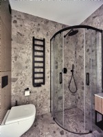 Modern bathroom with shower and stone like tiles