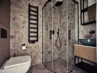 Modern bathroom with shower and stone like tiles