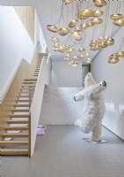Quirky polar bear sculpture in white contemporary hallway