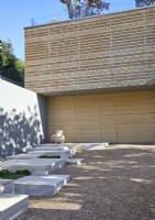 Marble slabs in gravel path outside contemporary building