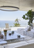 White contemporary living room with picture window and sea view