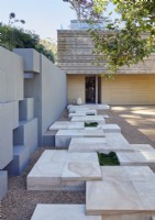 Unusual marble stepping stone pathway to contemporary house