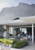 View of mountain above contemporary home with outdoor living space