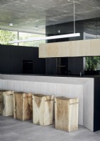 Large wooden block barstools in contemporary kitchen