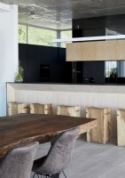Bar stools made from wooden logs in contemporary kitchen-diner