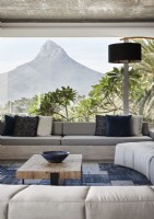 View of mountain through picture window in contemporary living room