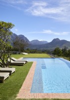 Swimming pool and garden with view of mountain range beyond