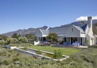 Exterior of modern country house with views of mountains beyond