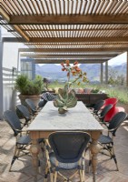 Outdoor living and dining area under the shade of a pergola