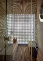 View of wooden sauna room with slatted walls 