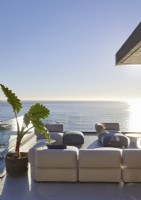 Sofas on terrace in large outdoor living area with sea views