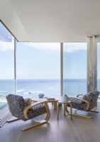 Animal print chairs facing sea view in contemporary living room