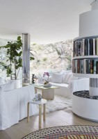 Contemporary white living room with rotating central bookshelf unit