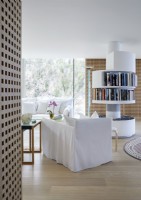 Rotating circular central bookshelves in contemporary living room