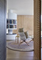 Circular rotating book shelves in centre of contemporary living room
