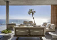 Large covered outdoor living area on terrace overlooking sea