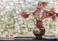 Detail of vase with tropical cut flower arrangement 