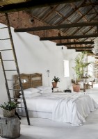 White painted modern rustic bedroom with vaulted ceiling