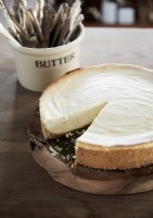 Detail of cheesecake on wooden chopping board